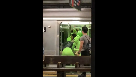 'Aliens' in neon bodysuits assault teens on NYC subway train
