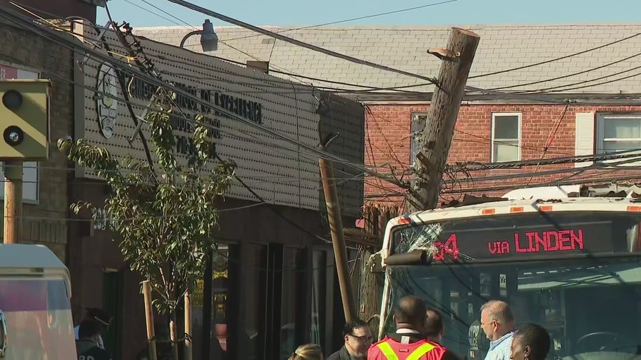 Utility pole leaning on roof of an MTA bus