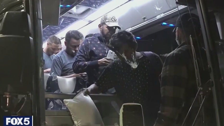 A charter bus carrying asylum-seekers arrives in Manhattan