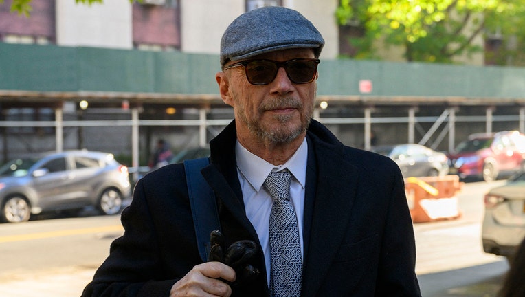 Paul Haggis wearing sunglasses and a hat