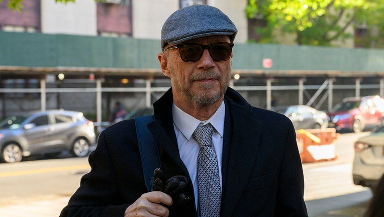 Paul Haggis wearing sunglasses and a hat 