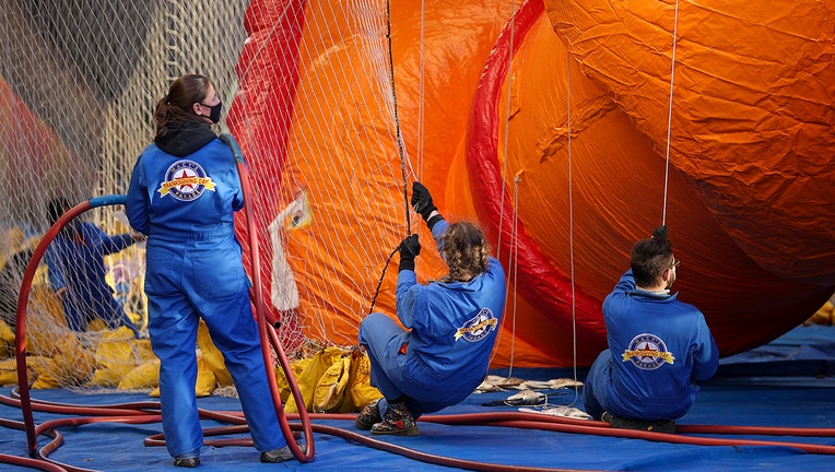 The Macy's inflation team works on giant balloons as they prepare ahead of the 95th Macy's Thanksgiving Day Parade in New York City, United States on November 24, 2021. (Photo by Tayfun Coskun/Anadolu Agency via Getty Images)