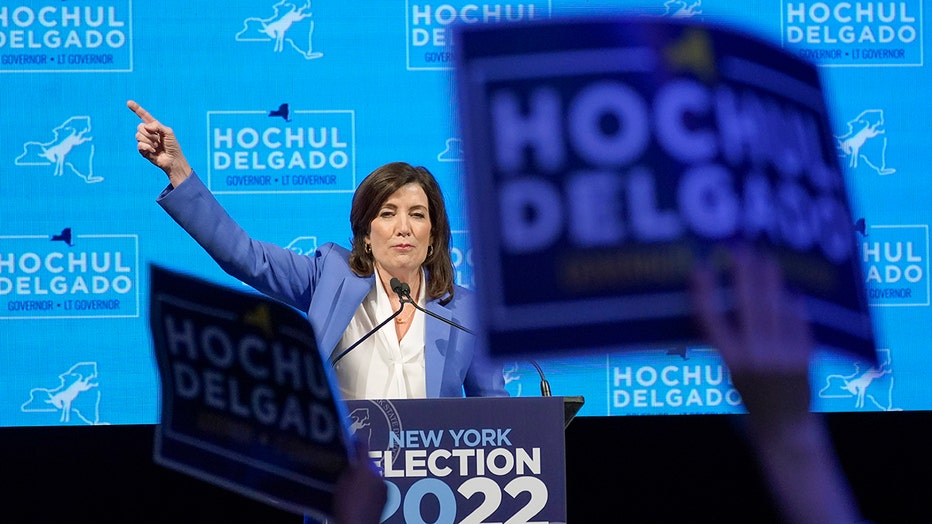 Gov. Kathy Hochul on stage behind mics