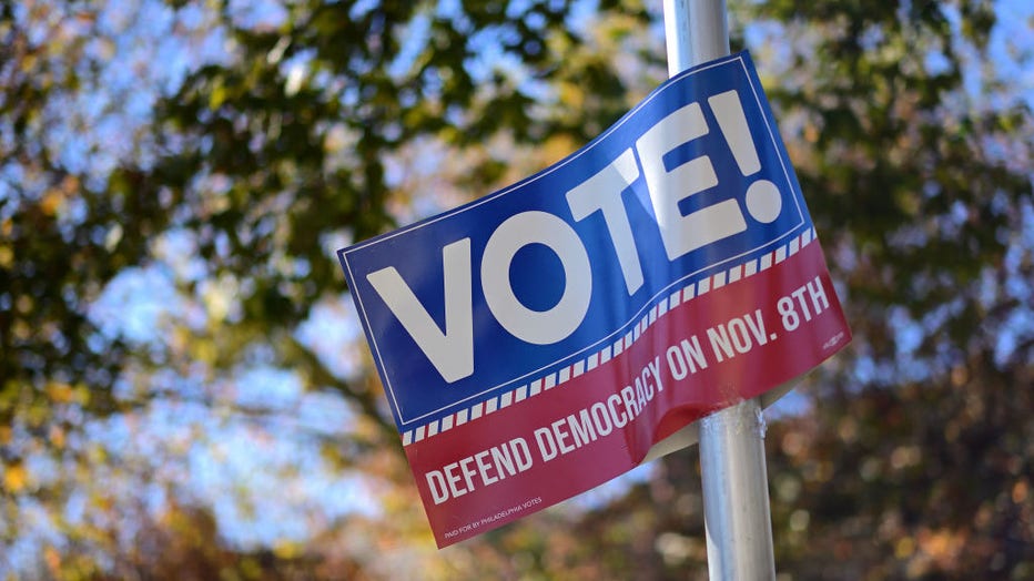 A sign that states "VOTE DEFEND DEMOCRACY on NOV. 8th" is affixed to a street pole the day before the midterm general election on Nov. 7, 2022, in Philadelphia, Pennsylvania. (Photo by Mark Makela/Getty Images)