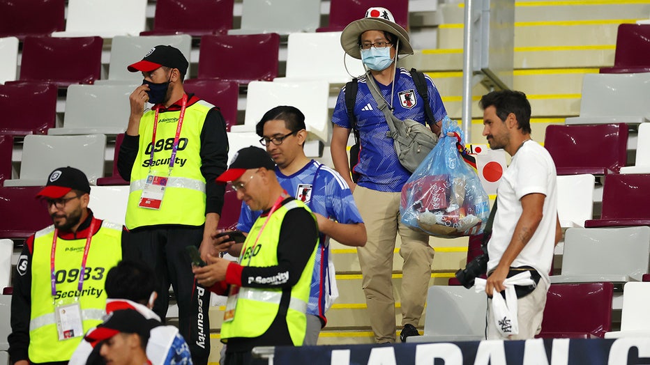 Japanese fans clear rubbish from the stands during the FIFA World Cup Qatar 2022 Group E match between Germany and Japan at Khalifa International Stadium on November 23, 2022 in Doha, Qatar. (Photo by Alex Grimm/Getty Images)