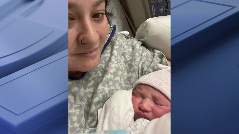 Rebecca Reyes poses with her newborn, Owen.