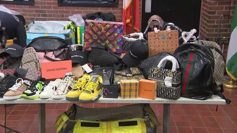 A table displaying various counterfeit goods was shown at an NYPD news conference.