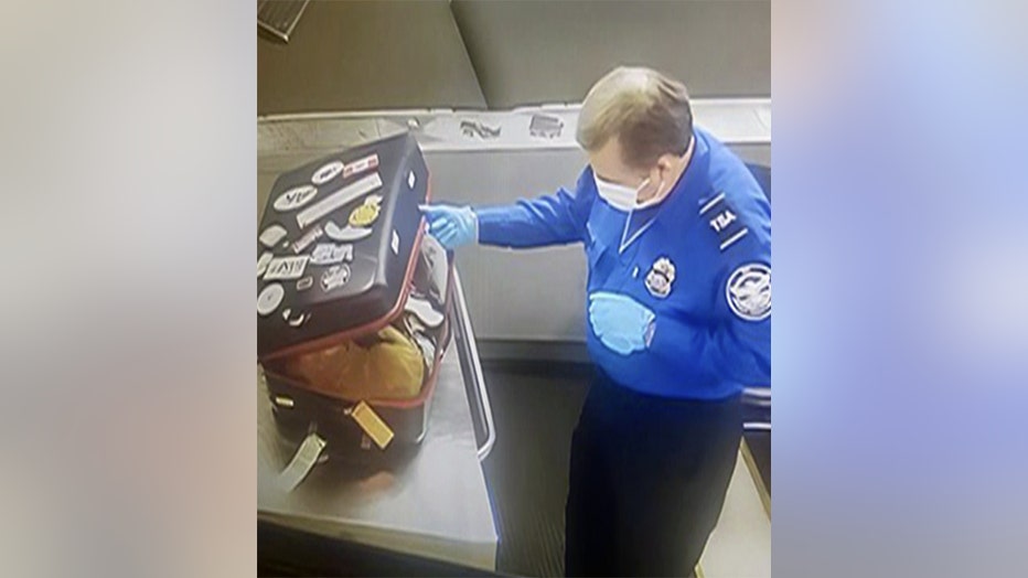 JFK baggage screening officer slowly opening bag with live cat inside