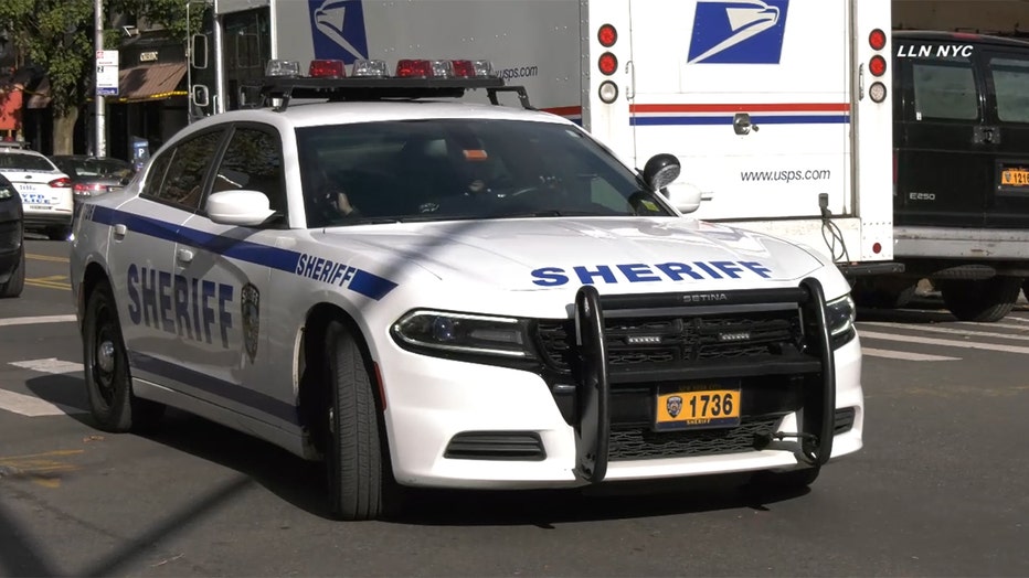 A white and blue sheriff's car