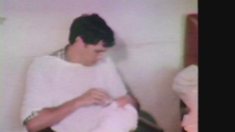 Alan Rosenberg feeds one of his twins who was born during the 1977 NYC blackout.