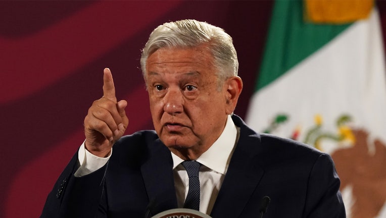 FILE - Mexico's President Andres Manuel Lopez Obrador speaks during his daily press conference at the National Palace, in Mexico City, Wednesday, June 22, 2022. Lopez Obrador appealed to the country’s citizens Tuesday, Dec. 27, not to accept holiday handouts and gifts from drug gangs, after videos posted online showed garish pickup trucks handing out loads of gifts while bystanders described the drivers as members of the Jalisco drug cartel. (AP Photo/Marco Ugarte, File)