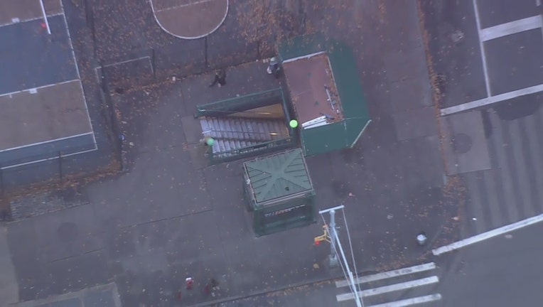 The entrance of the West Fourth St. and Sixth Ave. station is seen from above.