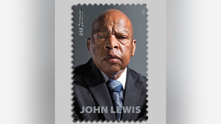 Image of a postage stamp showing the late John Lewis; he wears a blue tie, white shirt and gray suit