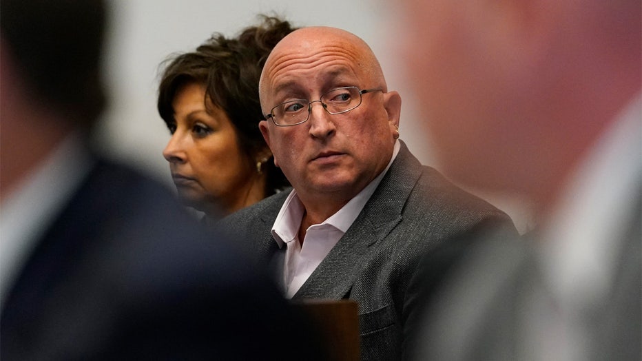 FILE - Robert E. Crimo III's father Robert Crimo Jr., right, and mother Denise Pesina attend to a hearing for their son in Lake County court on Aug. 3, 2022, in Waukegan, Ill. Prosecutors announced Friday, Dec. 16, that Crimo Jr., the father of the Illinois man charged with killing seven people in a mass shooting at a July 4 parade in a Chicago suburb, has been charged with seven felony counts of reckless conduct. (AP Photo/Nam Y. Huh, Pool, File)