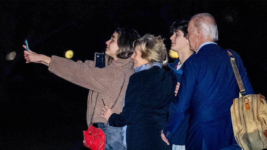 President Joe Biden, first lady Jill Biden, and their grandchildren Natalie and Robert, take a selfie before boarding Marine One on the South Lawn of the White House in Washington, Tuesday, Dec. 27, 2022, for a short trip to Andrews Air Force Base, Md., and then on to St. Croix, U.S. Virgin Islands. (AP Photo/Andrew Harnik)