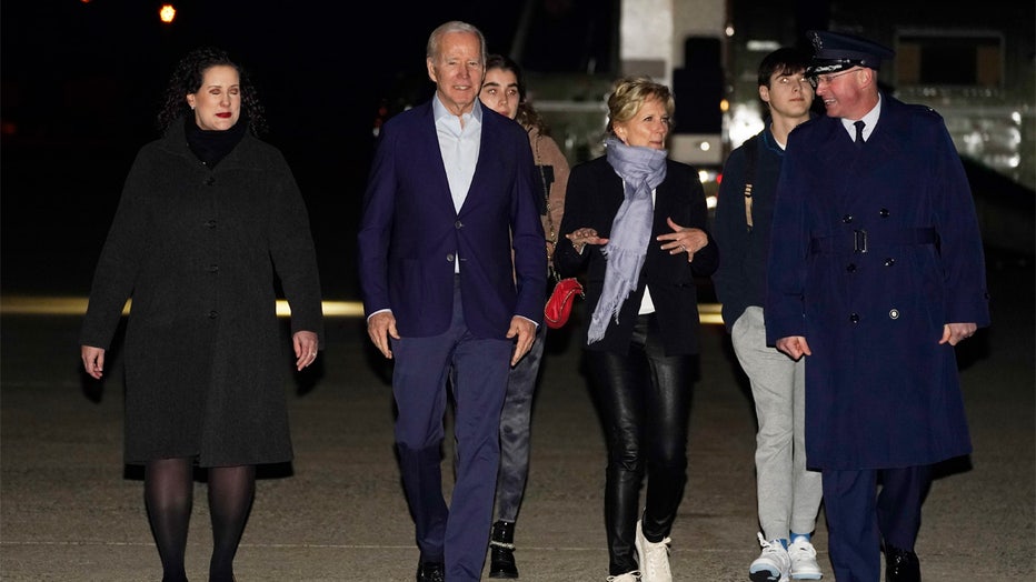 President Joe Biden and first lady Jill Biden arrive to board Air Force One at Andrews Air Force Base, Md., on Tuesday, Dec. 27, 2022, with their grandchildren Natalie and Robert and escorted by Air Force Col. William Chris McDonald, right, and his wife Diana McDonald, left. Biden and his family are traveling to St. Croix, U.S. Virgin Islands. (AP Photo/Manuel Balce Ceneta)