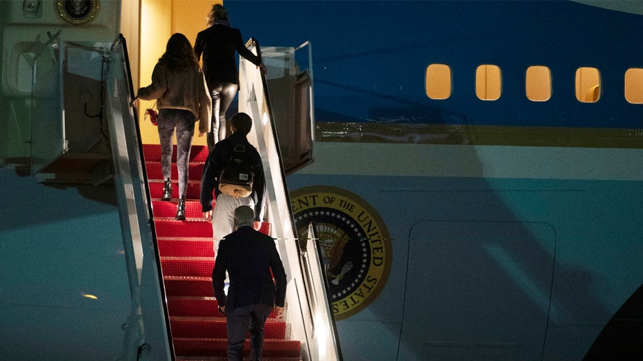 President Joe Biden, bottom, first lady Jill Biden, top, and their grandchildren Natalie and Robert, board Air Force One at Andrews Air Force Base, Md., Tuesday, Dec. 27, 2022. Biden and his family are traveling to St..Croix, U.S. Virgin Islands to celebrate the New Year. (AP Photo/Cliff Owen)