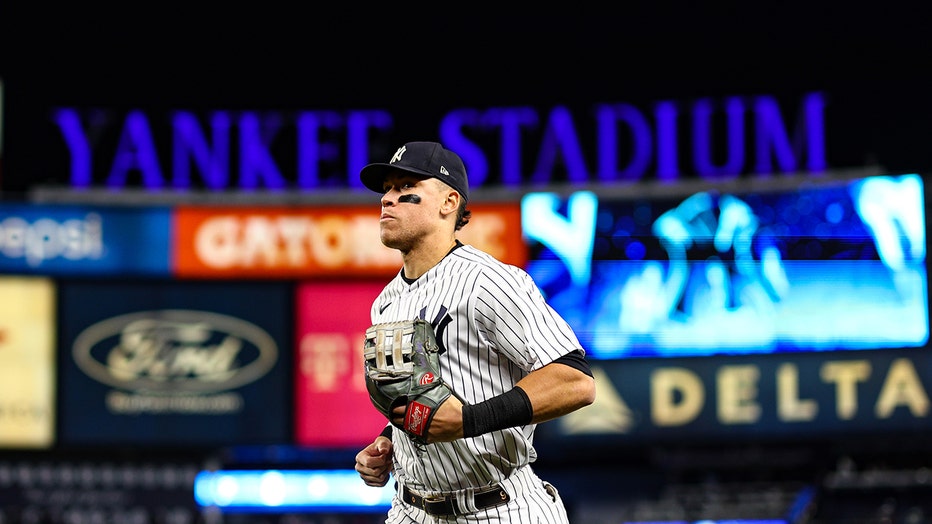 Aaron Judge #99 of the New York Yankees runs to the dugout after the fifth inning against the Houston Astros in game four of the American League Championship Series at Yankee Stadium on October 23, 2022. (Photo by Elsa/Getty Images)