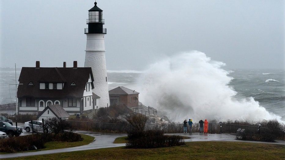 A wave slams into the rocks at Portland Head Light, Maine, during a powerful winter storm, Friday, Dec. 23, 2022, in Cape Elizabeth, Maine. (AP Photo/Robert F. Bukaty)