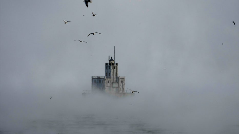 Steam rises off of Lake Michigan as morning temperatures remain below zero with heavy winds Friday, Dec. 23, 2022, in Milwaukee. Winter weather is blanketing the U.S. as a massive storm sent temperatures crashing and created whiteout conditions. (AP Photo/Morry Gash)