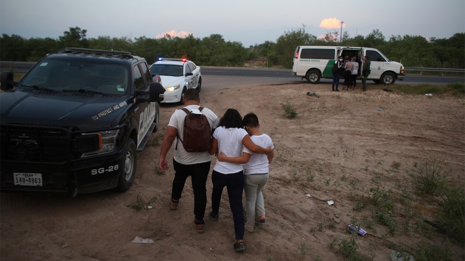 FILE - A migrant family who earlier crossed the Rio Grande river into the United States is taken away by Border Patrol agents in Eagle Pass, Texas, Saturday, May 21, 2022. The Eagle Pass area has become increasingly a popular crossing corridor for migrants, especially those from outside Mexico and Central America, under Title 42 authority, which expels migrants without a chance to seek asylum on grounds of preventing the spread of COVID-19. (AP Photo/Dario Lopez-Mills)