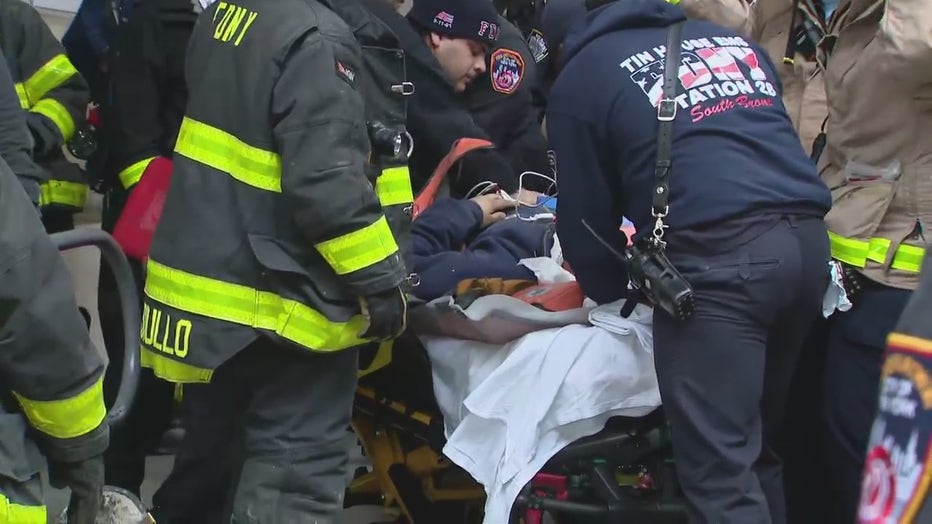 A victim was placed on a stretcher after being pulled from a Bronx elevator shaft.