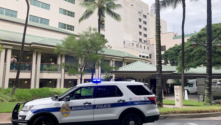 FILE - A Honolulu Police vehicle is parked outside of The Queen's Medical Center, where some patients injured by air turbulence on a Hawaiian Airlines flight from Phoenix to Honolulu were taken, Sunday, Dec. 18, 2022, in Honolulu. A preliminary report by the National Transportation Safety Board released Friday, Jan. 13, 2023, says the pilots of a Hawaiian Air plane that hit severe turbulence last month told investigators they had less than three seconds to react after a cloud shot up vertically in front of them at 38,000 feet on an otherwise clear day. Twenty-five people were injured in the Dec. 13, 2022, incident, including six who were seriously hurt. (AP Photo/Audrey McAvoy, File)