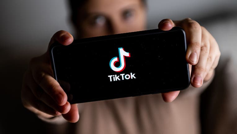 In this photo illustration a TikTok logo seen displayed on a