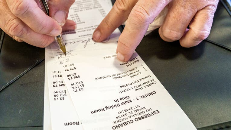 Coral Gables, Florida, pedestrian plaza and restaurant row, Espresso Cubano, signing credit card receipt