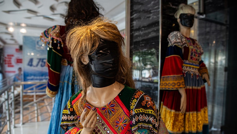 Faces are covered on female mannequins near shops on August 14, 2022 in Kabul, Afghanistan. Many murals, advertisements and mannequins featuring women were covered up after the Taliban retook power a year ago. The collapse of the economy and the freezing of Afghan and donor funds after the Taliban takeover of the country in August 2021 created a humanitarian crisis. Most art, culture and pastimes have been banned. The female population have also had to quit jobs and young girls after the age of 12 can no longer go to school or complete further education. (Photo by Nava Jamshidi/Getty Images)