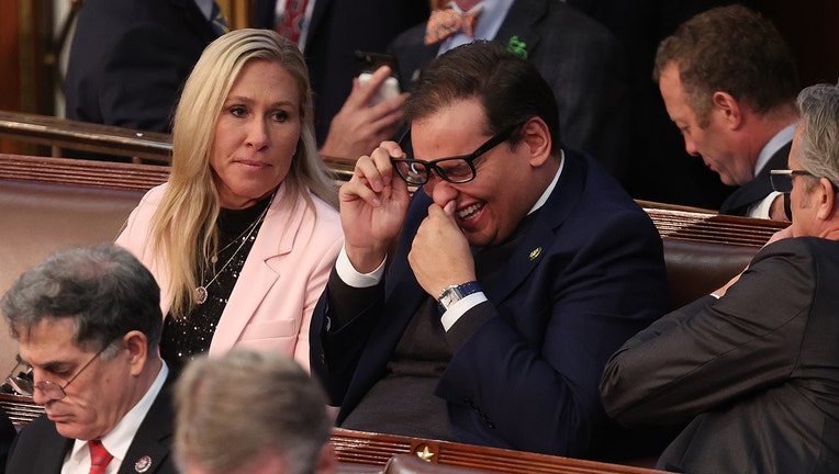 U.S. Rep. Marjorie Taylor Greene (R-GA) (L) talks to Rep.-elect George Santos (R-NY) in the House Chamber during the third day of elections for Speaker of the House at the U.S. Capitol Building on January 05, 2023 in Washington, DC. (Photo by Win McNamee/Getty Images)