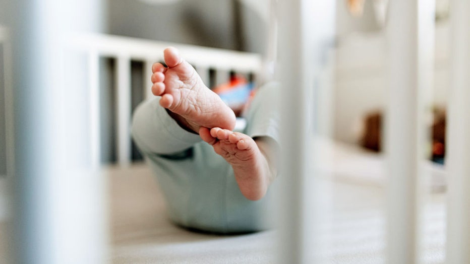 30 December 2019, North Rhine-Westphalia, Oberhausen: The feet of a baby can be seen in a crib. On 30.12.2019 the statistics of the hobby name researcher Knud Bielefeld on the most popular first names in 2019 were published in Ahrensburg (Schleswig-Holstein). Photo: Fabian Strauch/dpa (Photo by Fabian Strauch/picture alliance via Getty Images)