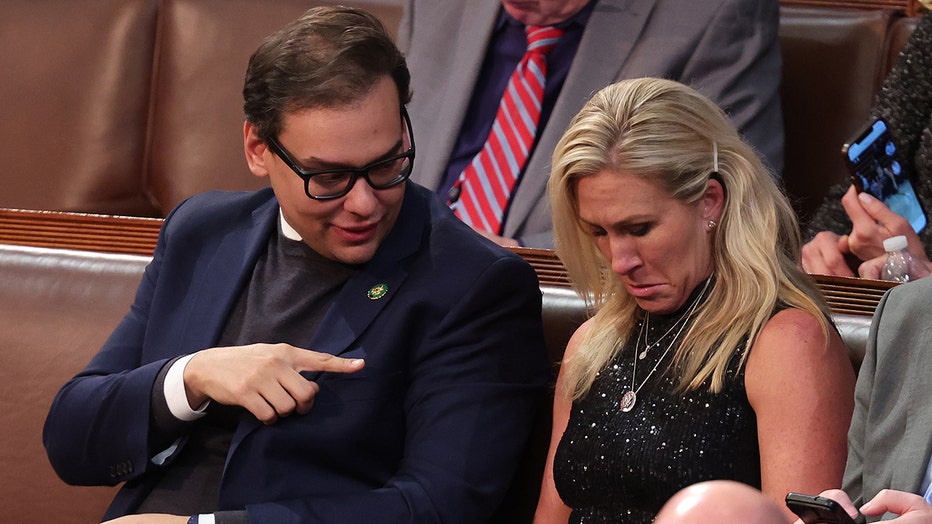 U.S. Rep. Marjorie Taylor Greene (R-GA) (L) talks to Rep.-elect George Santos (R-NY) in the House Chamber during the third day of elections for Speaker of the House at the U.S. Capitol Building on January 05, 2023 in Washington, DC. (Photo by Win McNamee/Getty Images)