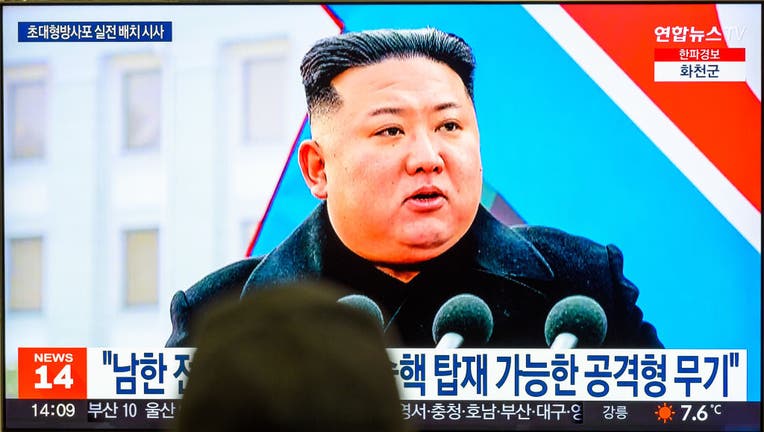 A TV screen shows footage of North Korean leader Kim Jong-