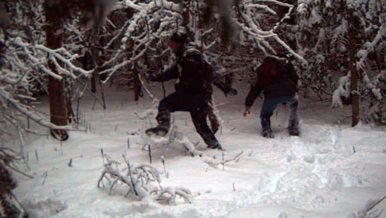 In this surveillance image provided by the United States Border Patrol Swanton sector, two individuals illegally cross the US/Canada border during January 2023 in the Vermont, New Hampshire and New York enforcement sector. (United States Border Patrol Swanton sector photo via AP)