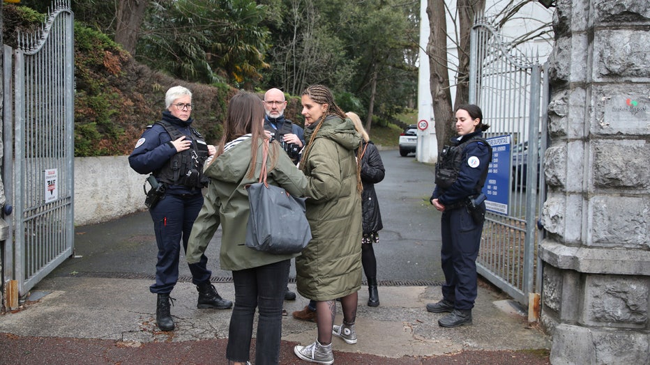 Police officers guard the entrance of a private Catholic school after a teacher has been stabbed to death by a high school student, Wednesday, Feb. 22, 2023 in Saint-Jean-de-Luz, southwestern France. The student has been arrested by police, the prosecutor of Bayonne said. (AP Photo/Bob Edme)