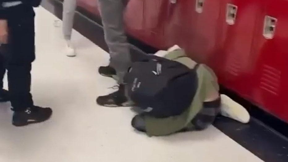 Adriana Kuch is seen on the floor of the school hallway after the attack.