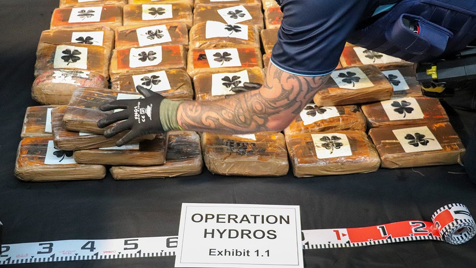 In this photo supplied by the New Zealand police, a shipment of cocaine found floating on the surface of the Pacific Ocean is stacked on a table in Auckland, New Zealand, Tuesday, Feb. 7, 2023. New Zealand police said Wednesday they found more than 3 tons of cocaine floating in a remote part of the Pacific Ocean after it was dropped there by an international drug-smuggling syndicate. (NZ Police via AP)