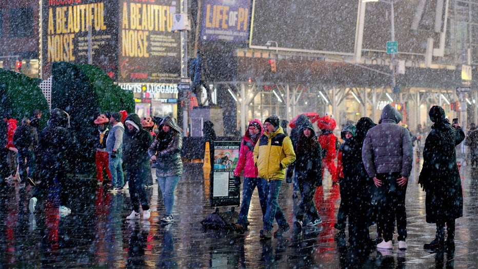 People visit Times Square during a snowfall on February 27, 2023 in New York City. (Photo by Leonardo Munoz / AFP) (Photo by LEONARDO MUNOZ/AFP via Getty Images)