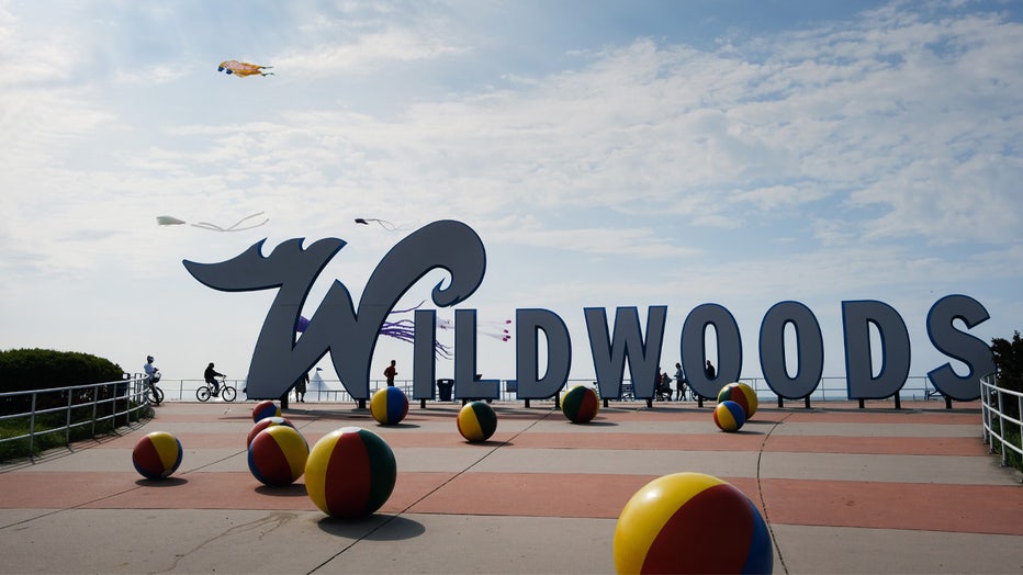 WILDWOOD, NEW JERSEY - MAY 28: People walk and ride along the boardwalk the day before the Memorial Day weekend, the unofficial start of summer, in the shore community of Wildwood on May 28, 2021 in Wildwood, New Jersey. Wildwood, like many beach communities throughout the United States, is looking for a successful and busy summer season after staying mostly closed or partially open last summer due to Covid-19 restrictions. Many resort community retail businesses are also suffering from a shortage of labor as some workers are choosing to stay home and others have changed career paths. (Photo by Spencer Platt/Getty Images)