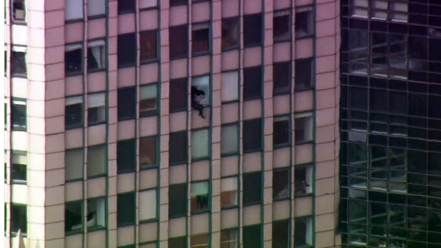 Standoff ends: FBI fugitive taken into custody after dangling from Midtown highrise