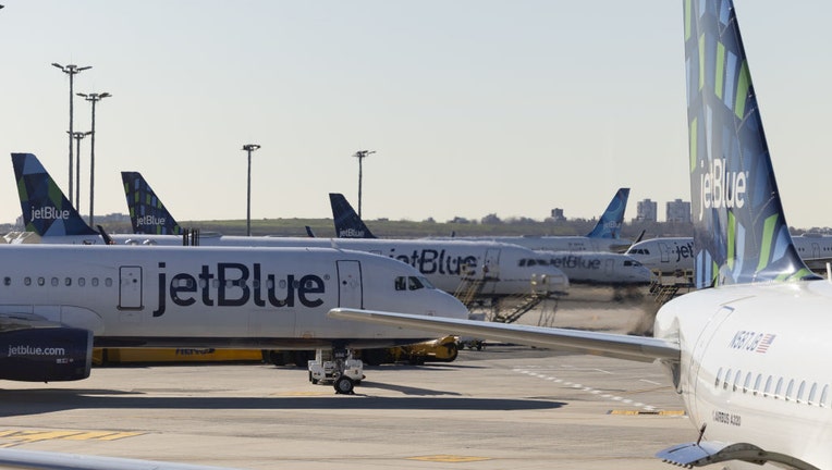 FILE - JetBlue planes at John F. Kennedy International Airport (JFK) in New York, U.S., on Nov. 24, 2021. Photographer: Angus Mordant/Bloomberg via Getty Images