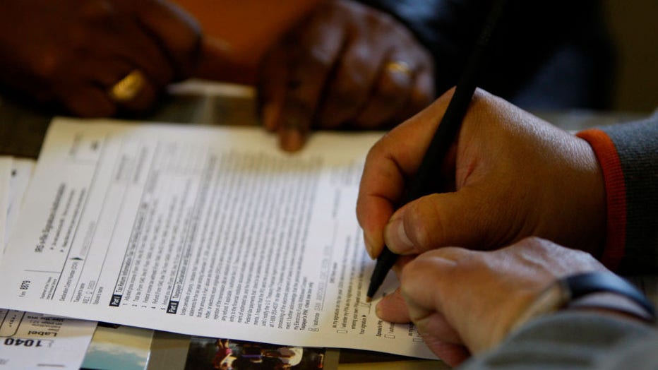 A client signs his income tax return after it was prepared free of charge at the San Antonio Community Development Corporation in Oakland, Calif., on Wednesday, March 25, 2009
