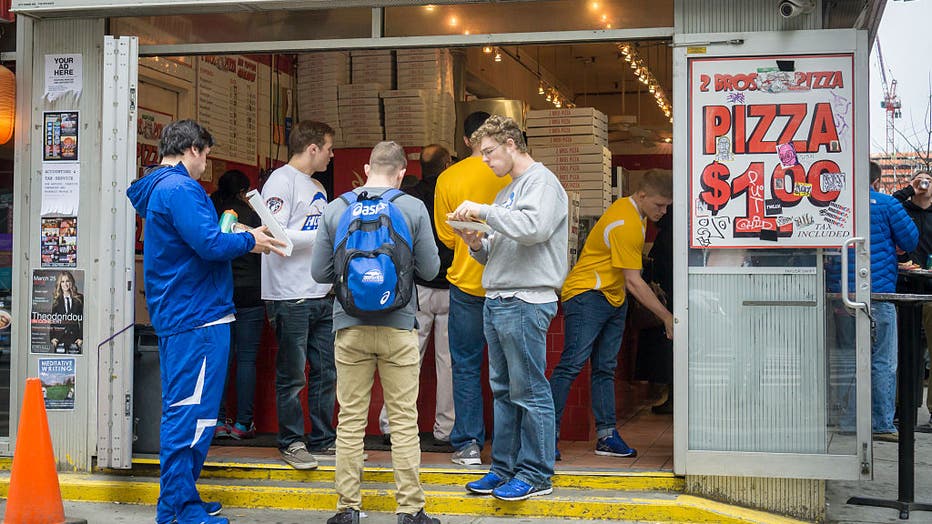 "Bros" eat dollar pizza at 2 Bros. in New York