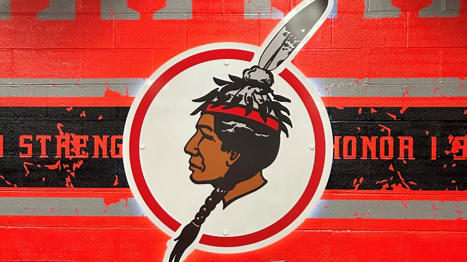 The logo of the Salamanca City Central School District is displayed on a wall at Salamanca High School in Salamanca, N.Y., on April 18, 2023. The school district, located on Seneca Nation of Indians territory, may have to replace its logo after New York passed a ban on the use of Indigenous names, mascots and logos by public schools. (AP Photo/Carolyn Thompson)