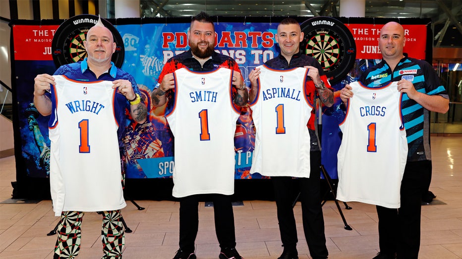NEW YORK, NEW YORK - MAY 31: (L-R) Peter Wright of Scotland, Michael Smith of England, Nathan Aspinall of England, and Robert Cross of England pose for photos during a media preview at Chase Square ahead of the 2023 bet365 US Darts Masters and North American Championship at Madison Square Garden on May 31, 2023 in New York City. (Photo by Sarah Stier/Getty Images)