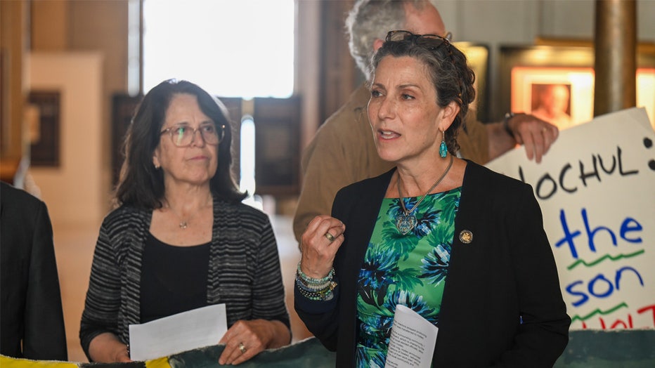 New York Assemblywoman Dana Levenberg, D-Ossining, stands with advocates during a rally at the state Capitol in Albany, N.Y., Tuesday, June 20, 2023, urging lawmakers and New York Gov. Kathy Hochul to pass the legislative bill "Save the Hudson", banning the dumping of toxic radioactive waste water from nuclear power plants into the Hudson River. (AP Photo/Hans Pennink)