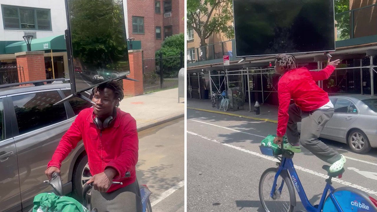 Watch New York man spotted balancing TV on his head while riding bike