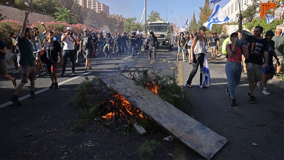 Israeli security forces deploy to remove protesters blocking the entrance of the Knesset, Israel's parliament, in Jerusalem on July 24, 2023, amid a months-long wave of protests against the government's planned judicial overhaul. Israel's hard-right government pushed through parliament a key clause of its controversial judicial reform package despite months of mass protests and concerns voiced by foreign allies. (Photo by HAZEM BADER / AFP) (Photo by HAZEM BADER/AFP via Getty Images)