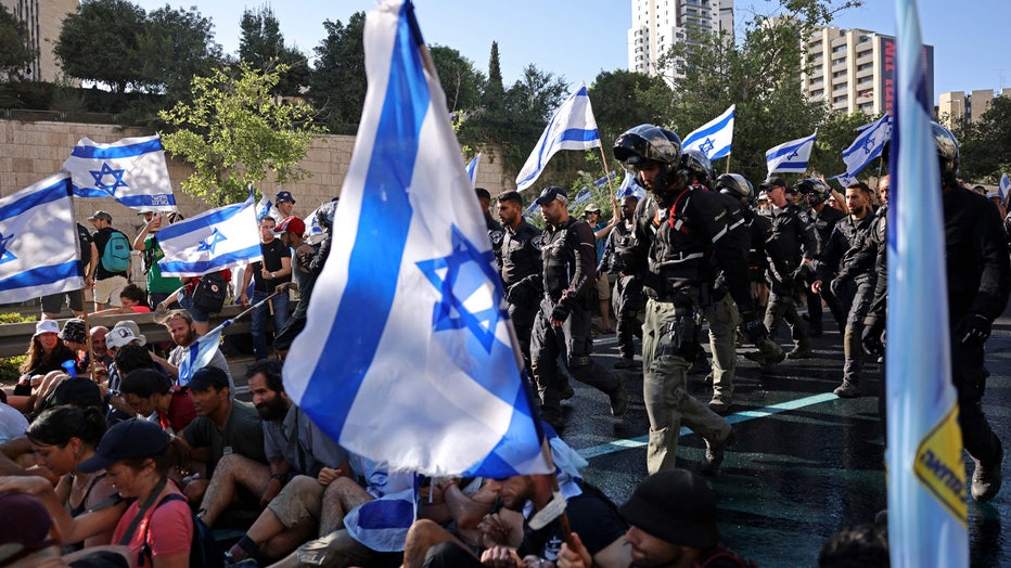 Israeli security forces remove protesters blocking the entrance of the Knesset, Israel's parliament, in Jerusalem on July 24, 2023, amid a months-long wave of protests against the government's planned judicial overhaul. Israel's hard-right government pushed through parliament a key clause of its controversial judicial reform package despite months of mass protests and concerns voiced by foreign allies. (Photo by HAZEM BADER / AFP) (Photo by HAZEM BADER/AFP via Getty Images)